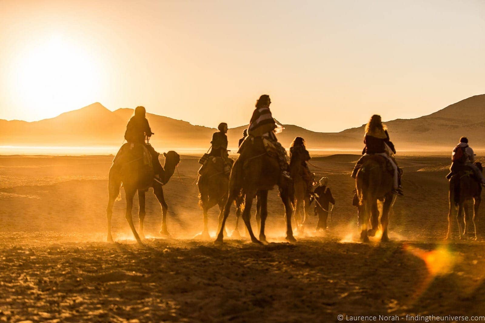 Camels and riders in desert Morocco 